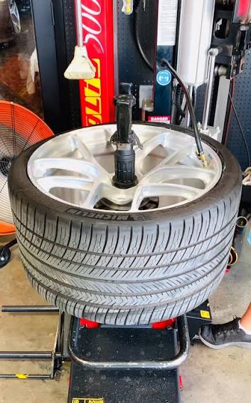 Tire and wheel positioned on a shop tire-mounting machine